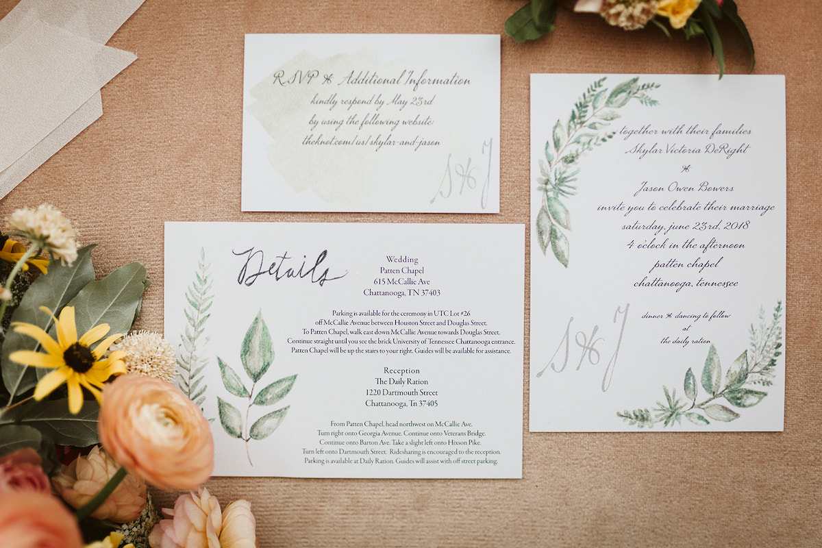 Watercolor wedding invitation and RSVP cards painted with greens and leaves