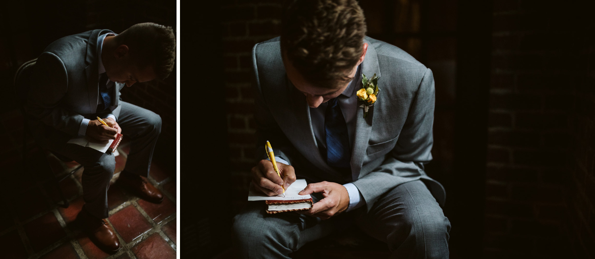 Groom wearing gray suit and yellow boutonniere sits and writes a note