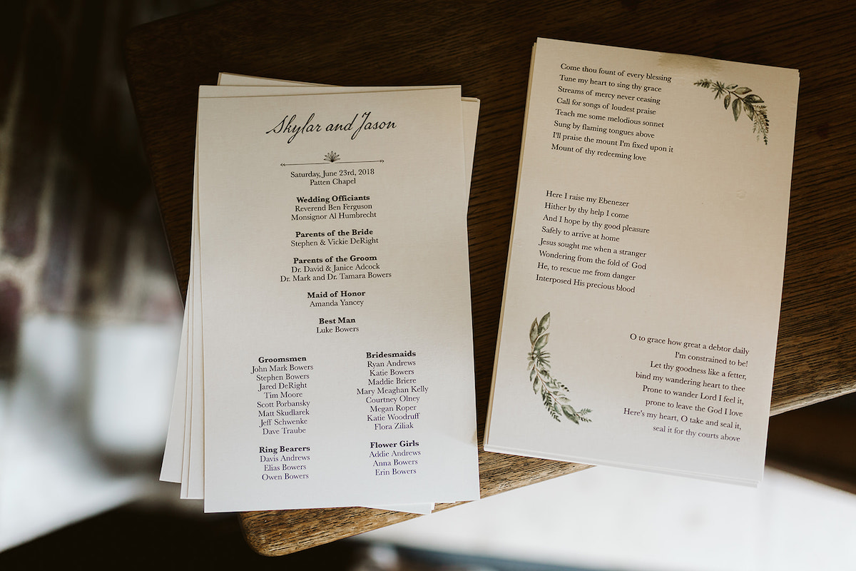 White wedding program lists wedding party and song lyrics