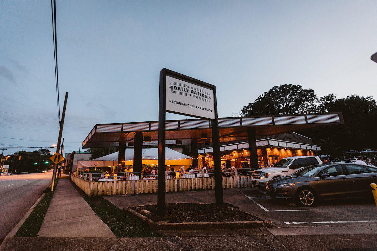 The covered patio of The Daily Ration lit with strings of patio lights