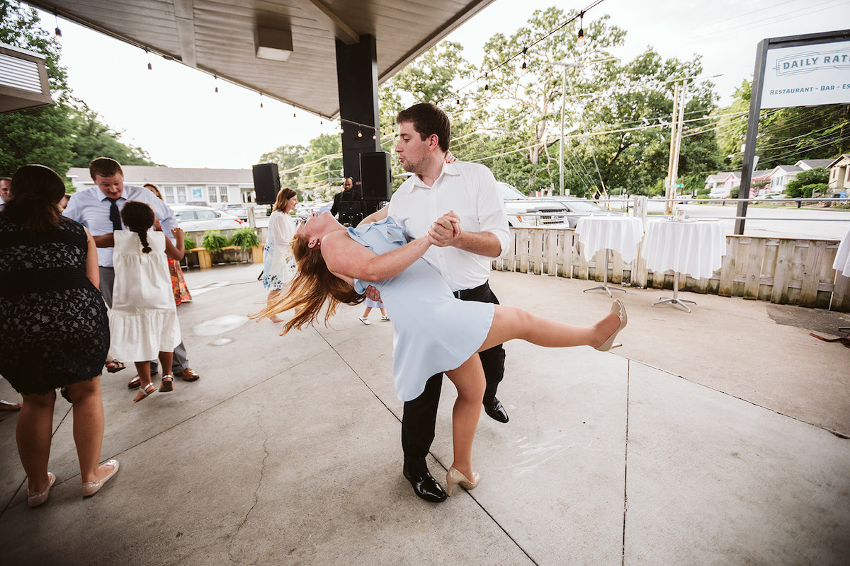 Man dips woman as they dance under outdoor patio cover at The Daily Ration