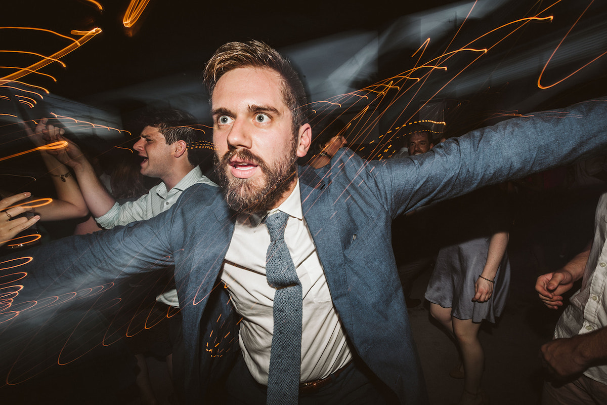 Party-goers dance under outdoor patio cover at The Daily Ration