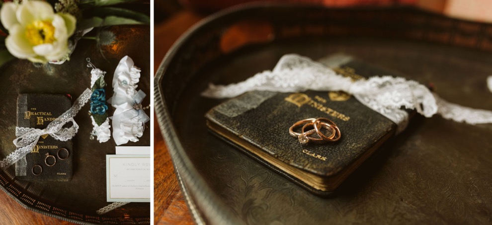 wedding rings on vintage leather book with garter lying nearby