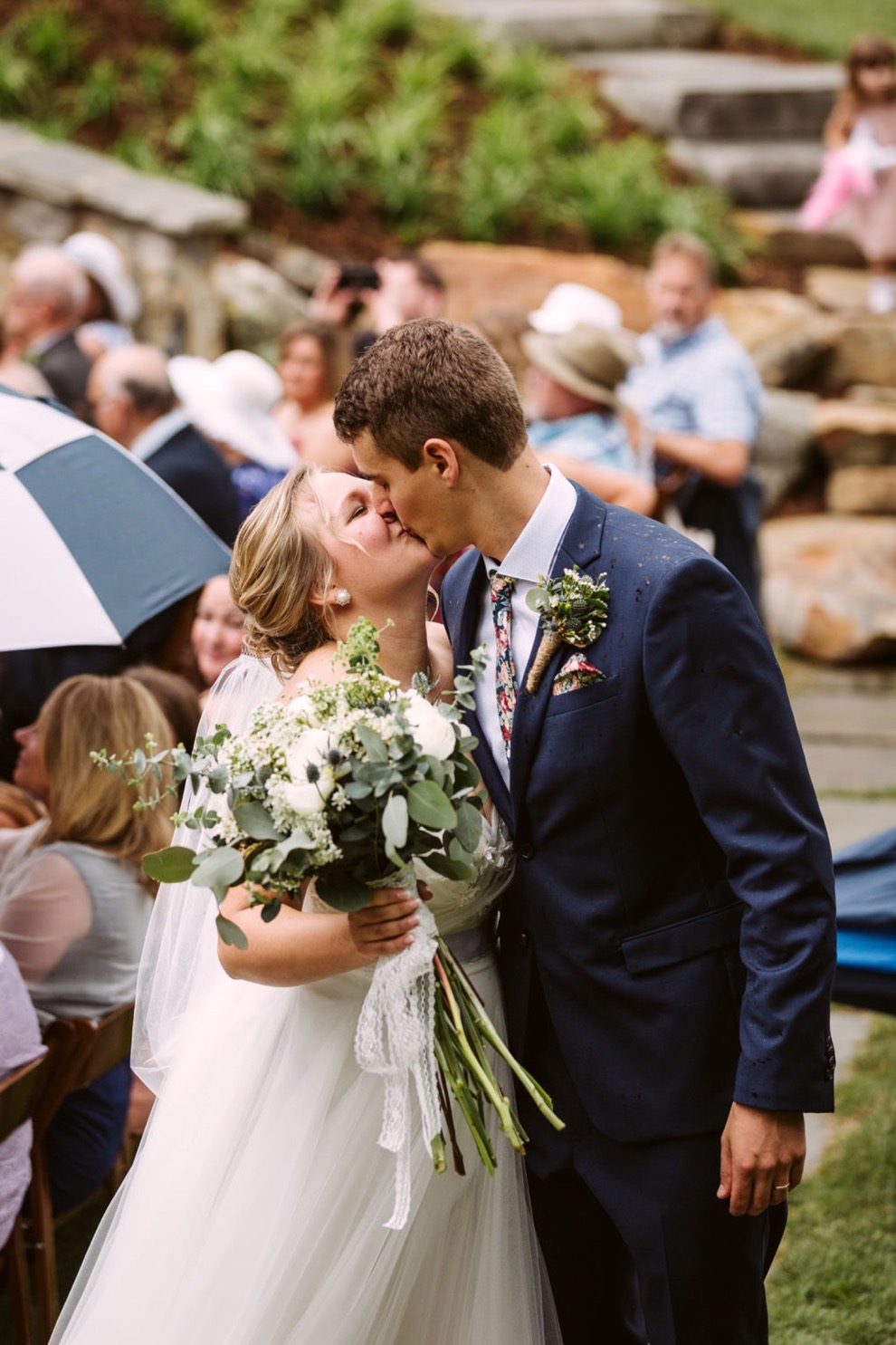 bride and groom kiss as they leave ceremony