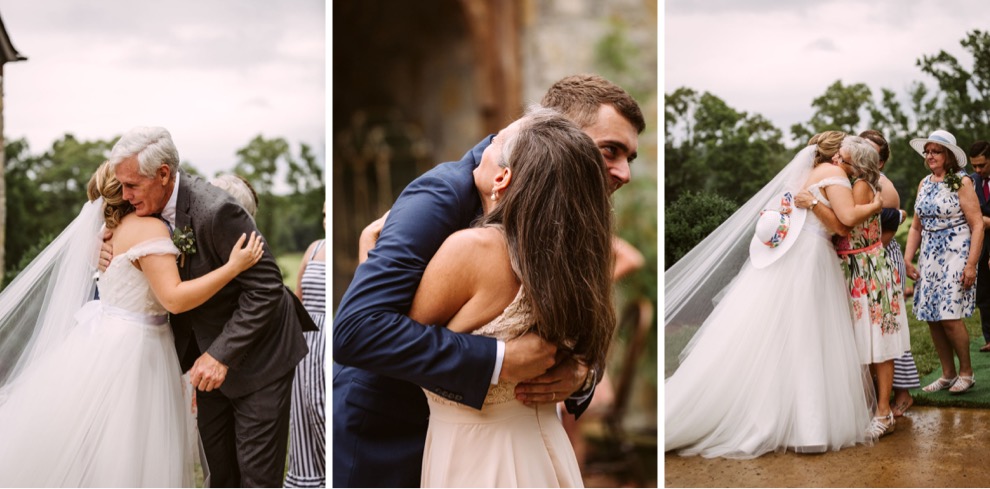 bride and groom hugging guests after wedding