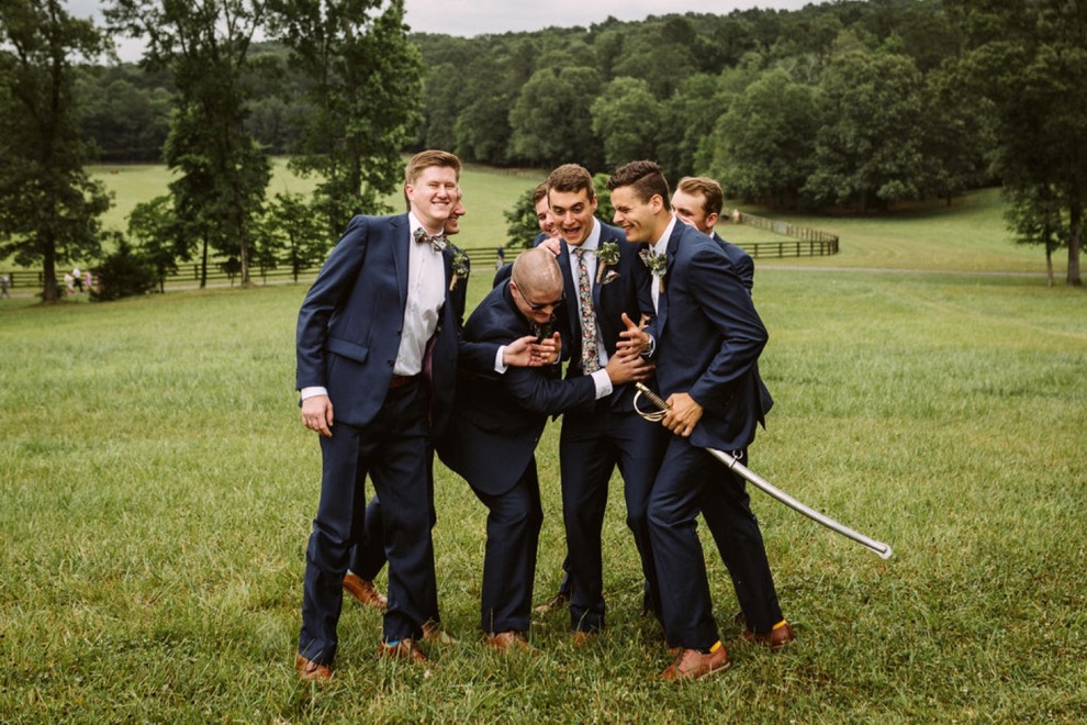 groomsmen posing outside for portraits