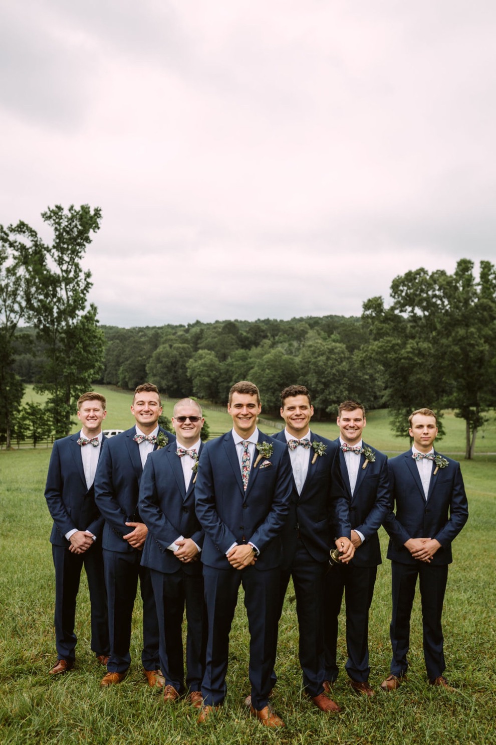 groomsmen posing outside for portraits