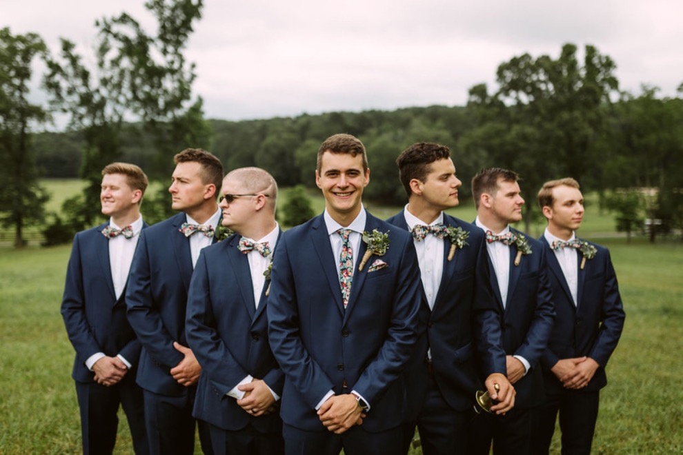 groomsmen posing outside for portraits