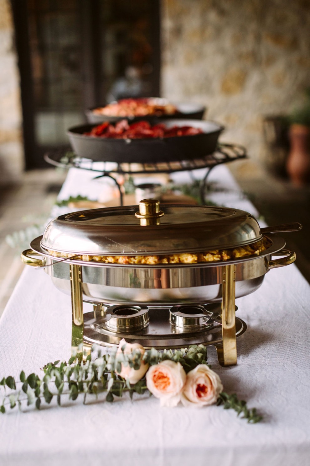 food in warming dishes at backyard brunch wedding