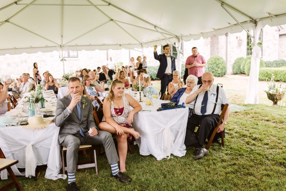 guests listening to wedding toasts