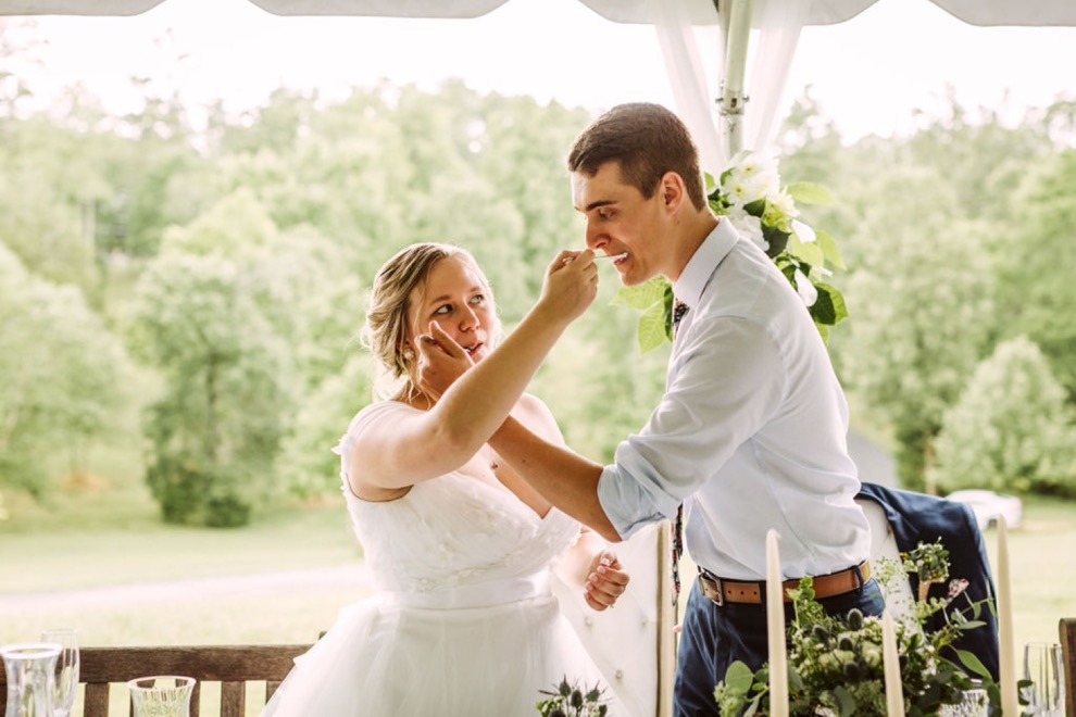 bride and groom feeding each other wedding cake on forks