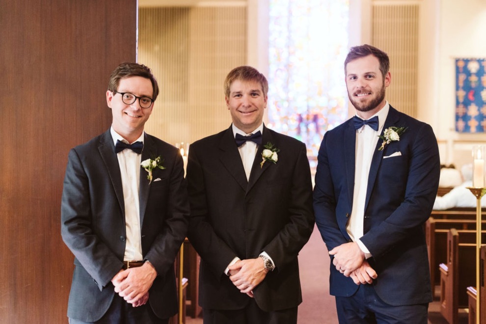 groomsmen standing at altar during cathedral wedding