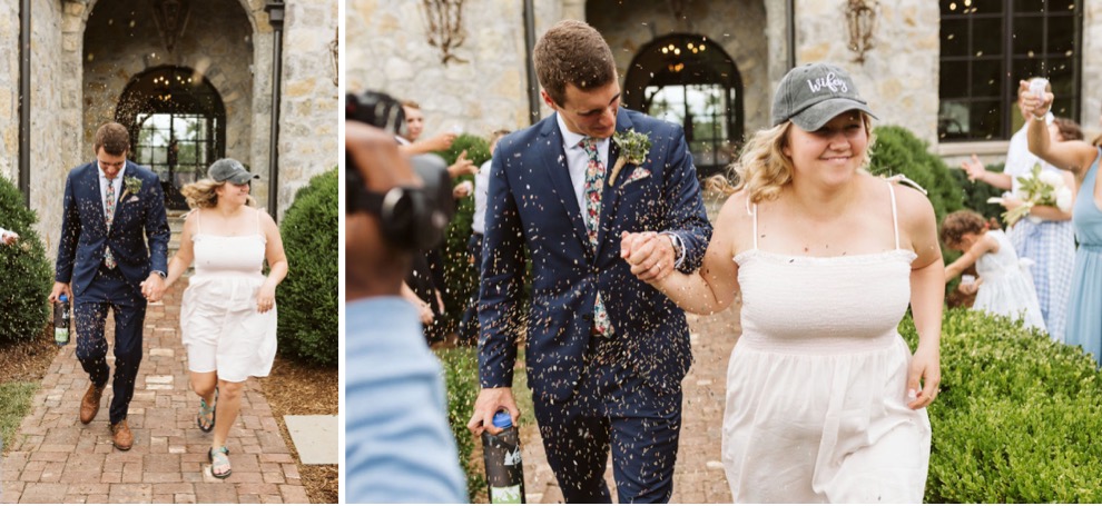 bride and groom running down brick path as guests toss birdseed. Bride wears a white sundress and baseball cap.