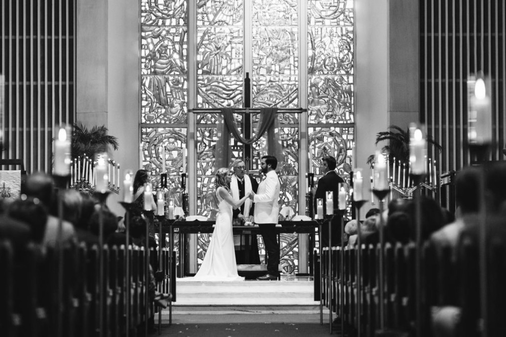 bride and groom standing at church altar during wedding ceremony