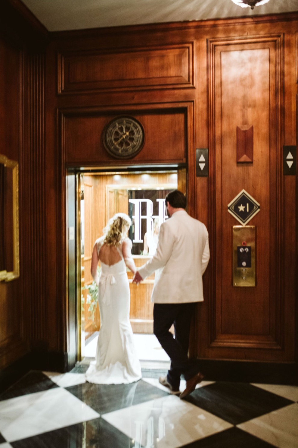 bride and groom walking into ornate elevator in downtown Chattanooga hotel