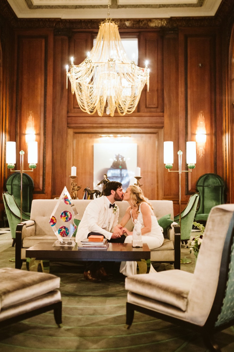 bride and groom kissing in vintage southern hotel lounge