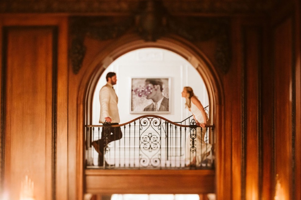 bride and groom standing in wooden hotel hallway