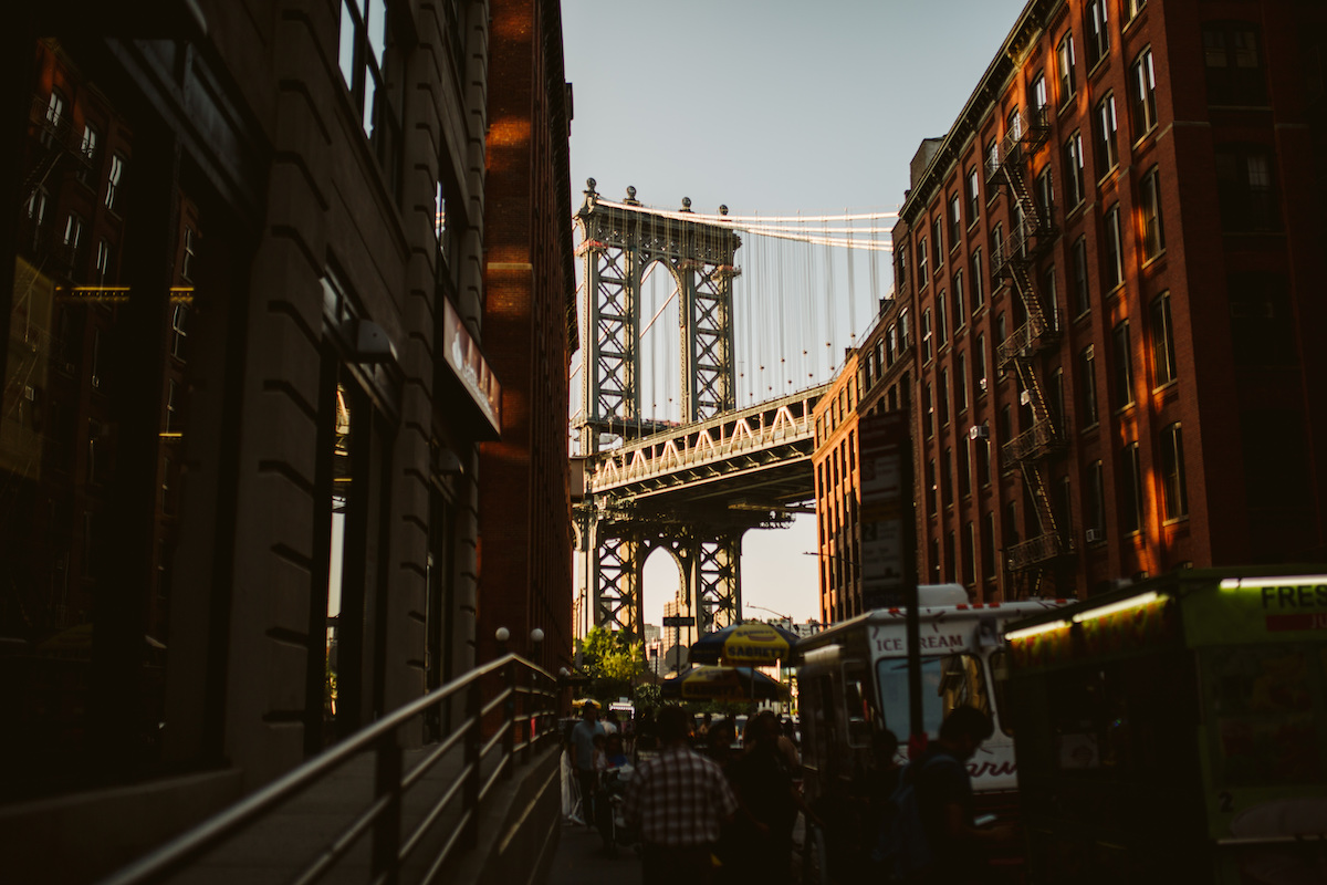 Shadowy side street leads to the Brooklyn Bridget lit with sunlight