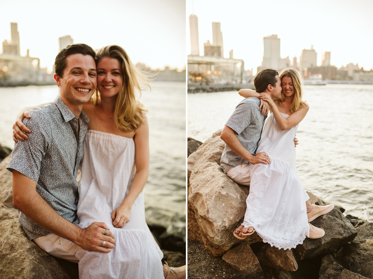 Man and woman cuddle on large rocks at the East River in New York City