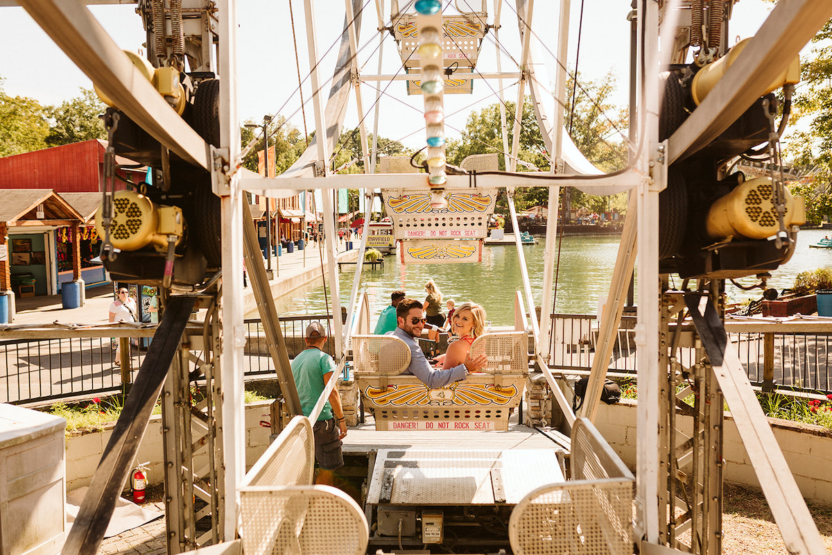 Man and woman ride ferris wheel at Lake Winnie in Chattanooga for engagement photos