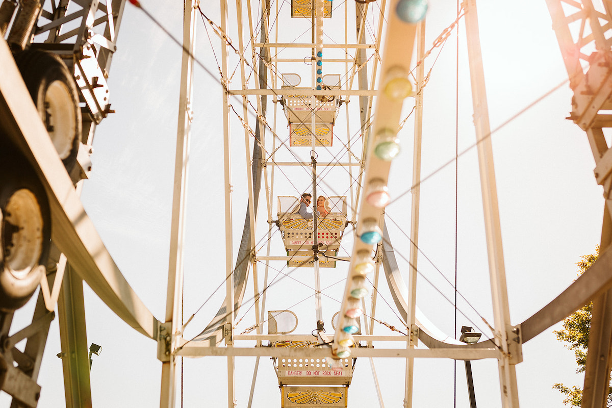 Man and woman ride ferris wheel at Lake Winnie in Chattanooga for engagement photos