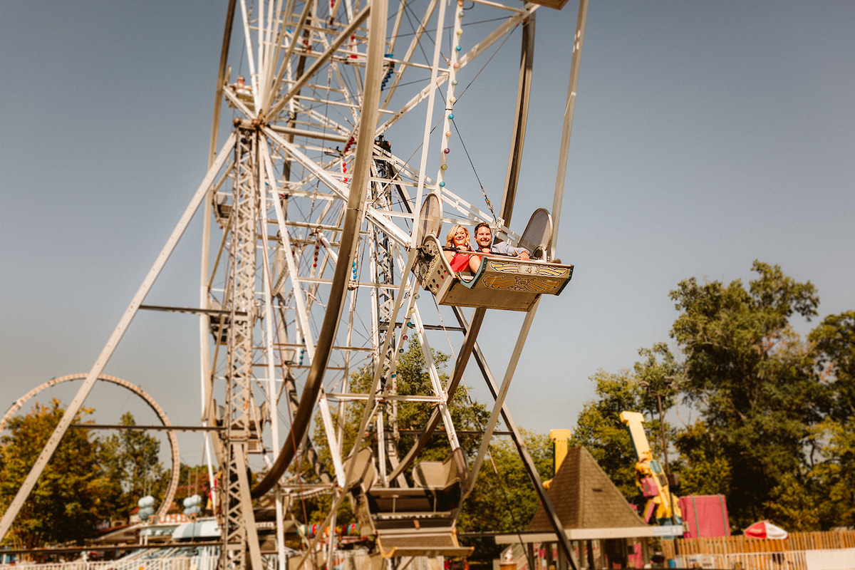Man and woman ride ferris wheel at Lake Winnie in Chattanooga for engagement photos