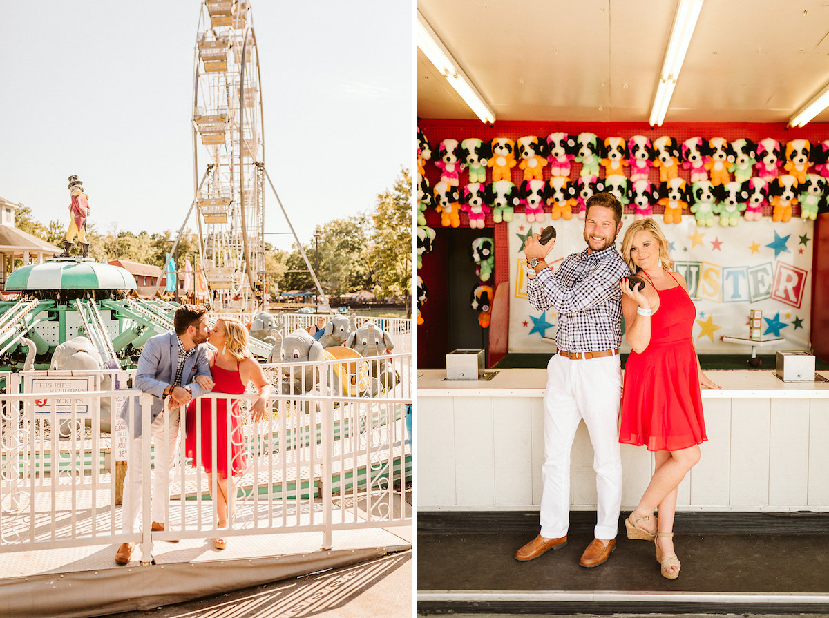 Man and woman kiss next to a metal frame fence near a carnival ride. Ferris wheel stands in the background.