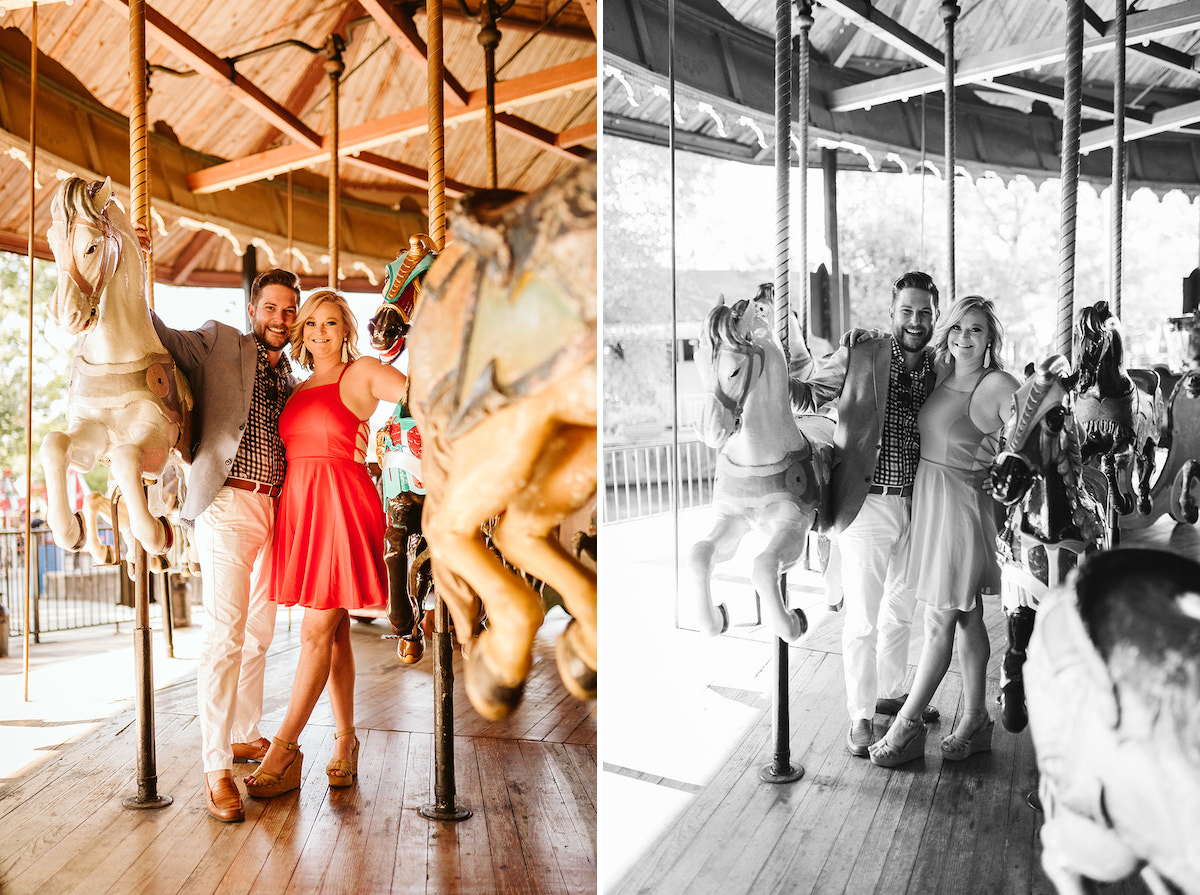 Man and woman stand between horses on Lake Winnie's carousel in Chattanooga, TN