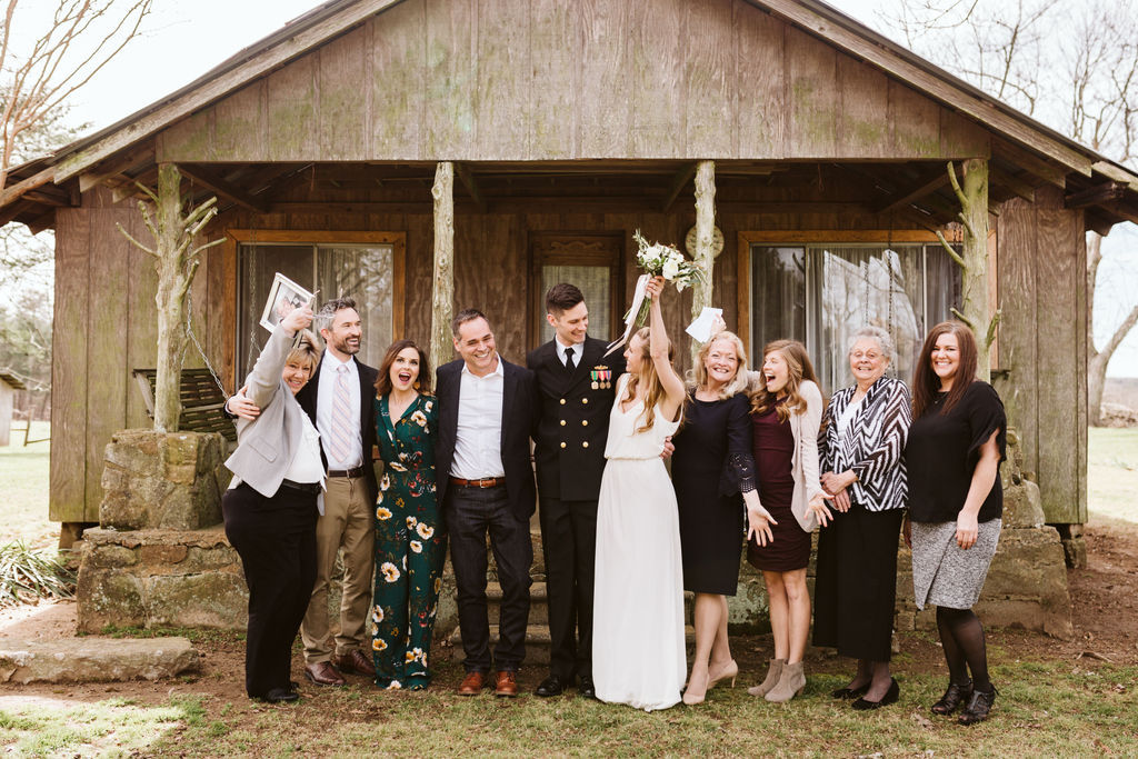 Bride and groom stand with their family members after their intimate elopement ceremony