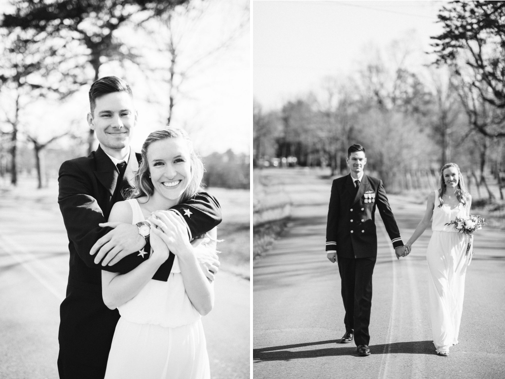 Bride and groom hold hands while walking down the middle of the road.