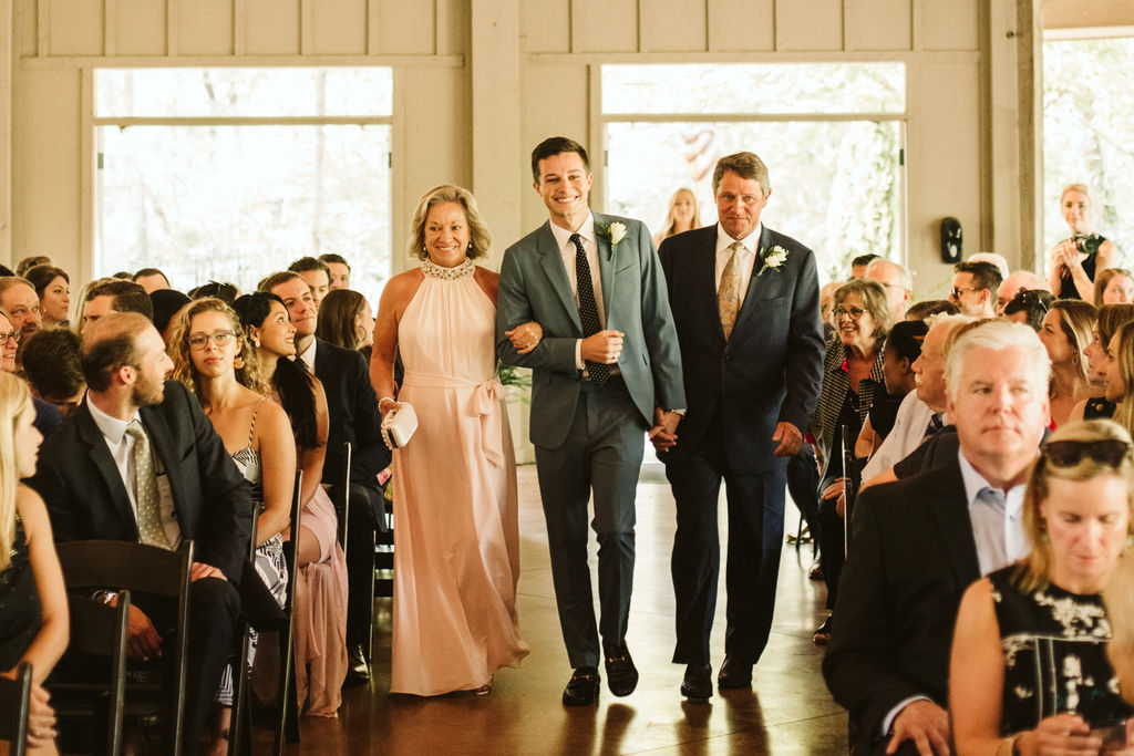 Groom with mother and father walking down the aisle toward his bride at Lookout Mountain wedding open-air pavilion ceremony