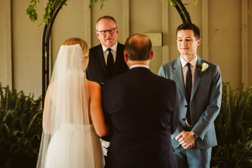 Back of bride and her father during giving-away portion of Lookout Mountain Chattanooga Tennessee wedding ceremony.