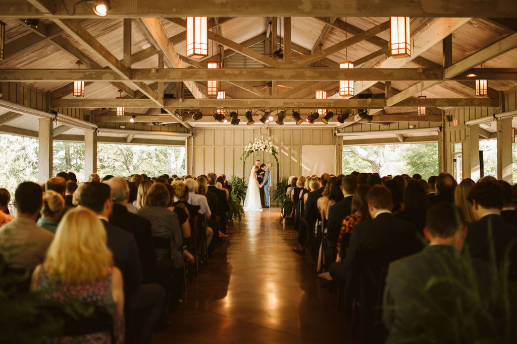 Bride and groom under floral arch at the front of a Lookout Mountain wedding open-air pavilion in Chattanooga Tennessee