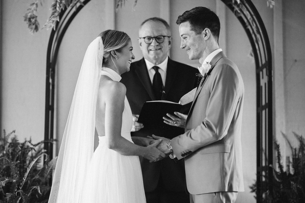 Bride and groom look into each other's eyes while minister looks on during Lookout Mountain Chattanooga Tennessee wedding