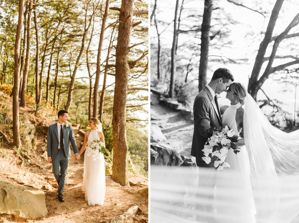 Bride and groom walk a dirt trail in the woods