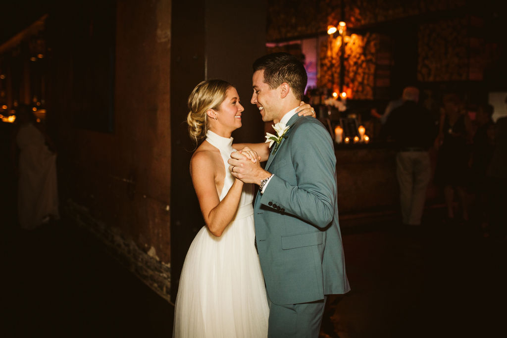 Bride and groom smile at each other during their first dance at their downtown Chattanooga wedding reception