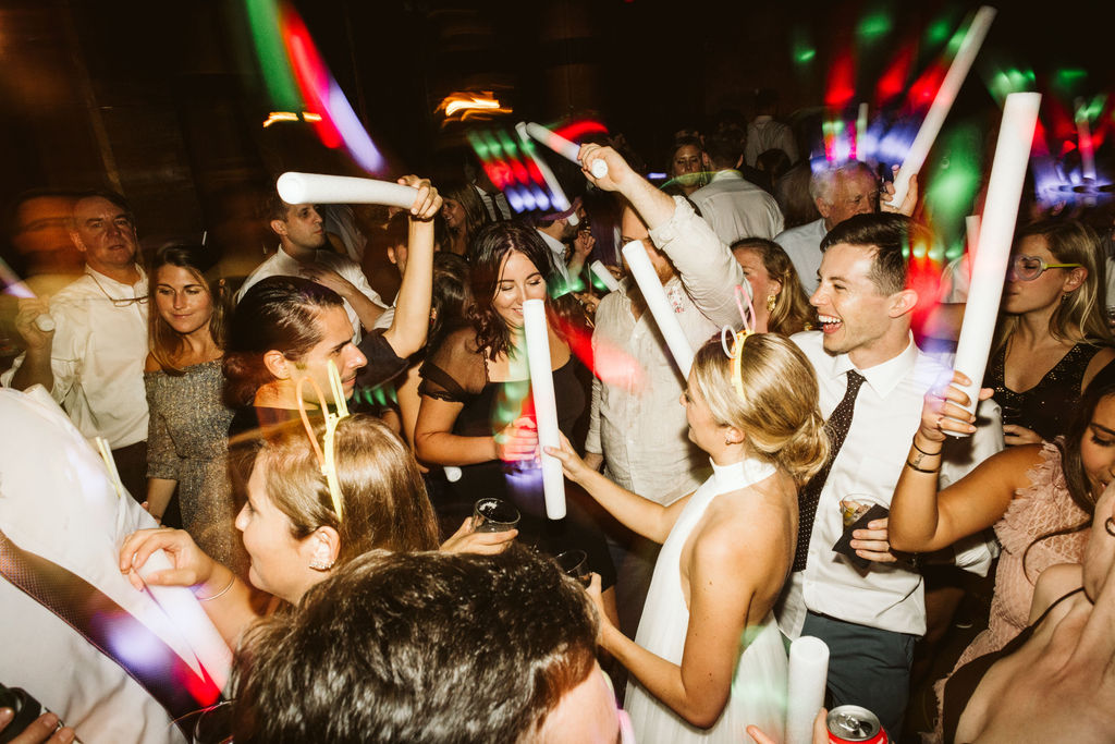 Wedding guests sing and dance with glow sticks