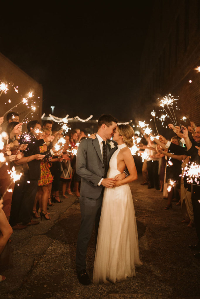 Bride and groom share a final kiss of the evening during sparkler send-off