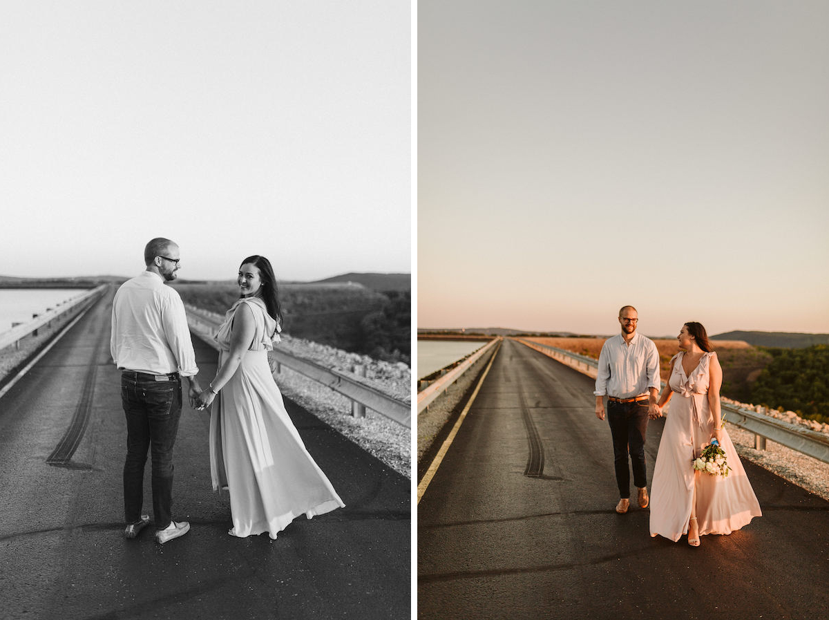 Man and woman walk hand-in-hand on Raccoon Mountain's loop drive at golden hour. She carries a bouquet of white flowers.