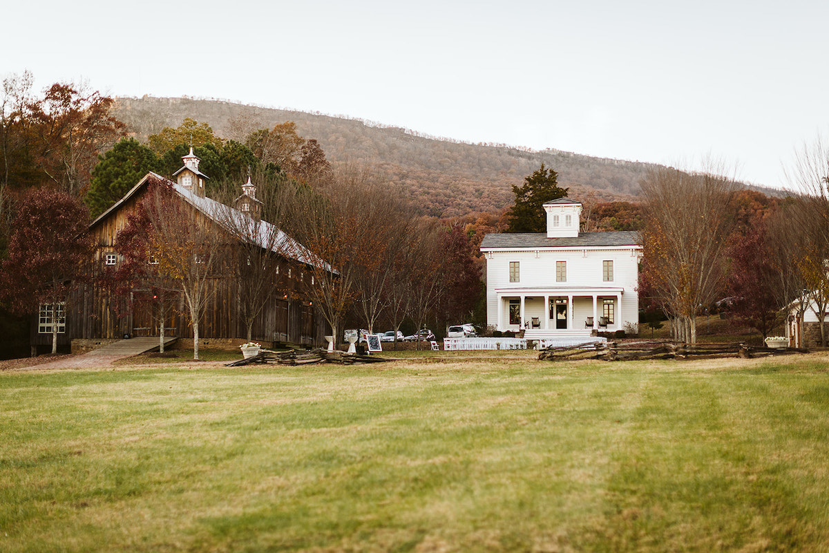 The formal green between the barn and Peacock Hall at The Homestead at Cloudland Station, Lookout Mountain in the background