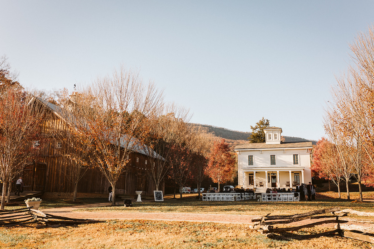 White chairs set up on the formal green between the barn and Peacock Hall at The Homestead at Cloudland Station Chattanooga