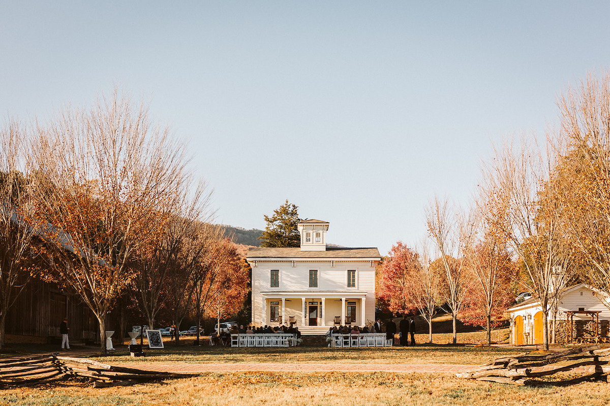 White chairs set up on the formal green between the barn and Peacock Hall at The Homestead at Cloudland Station Chattanooga