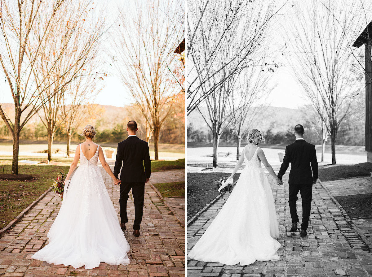 Bride and groom walk down antique brick carriage path toward trees