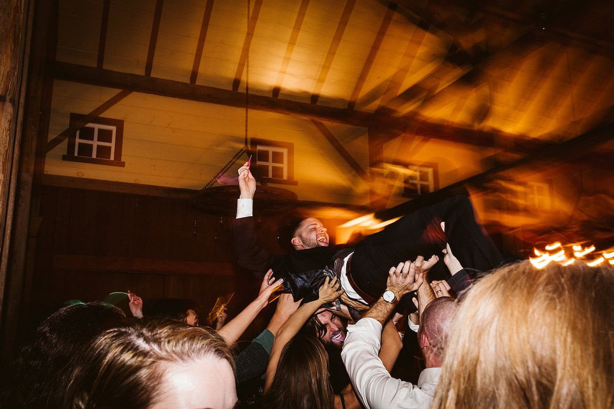 man crowd-surfs under the high ceiling of The Homestead at Cloudland Station