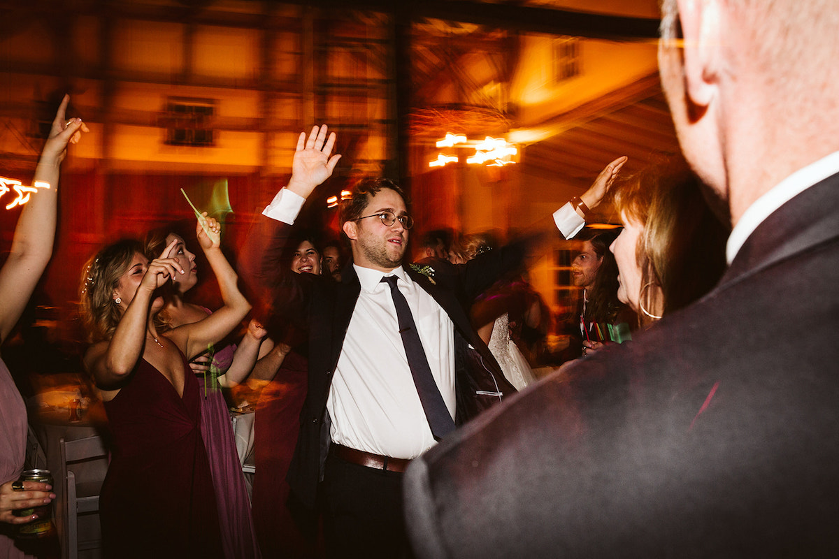 man in dark suit and tie dances