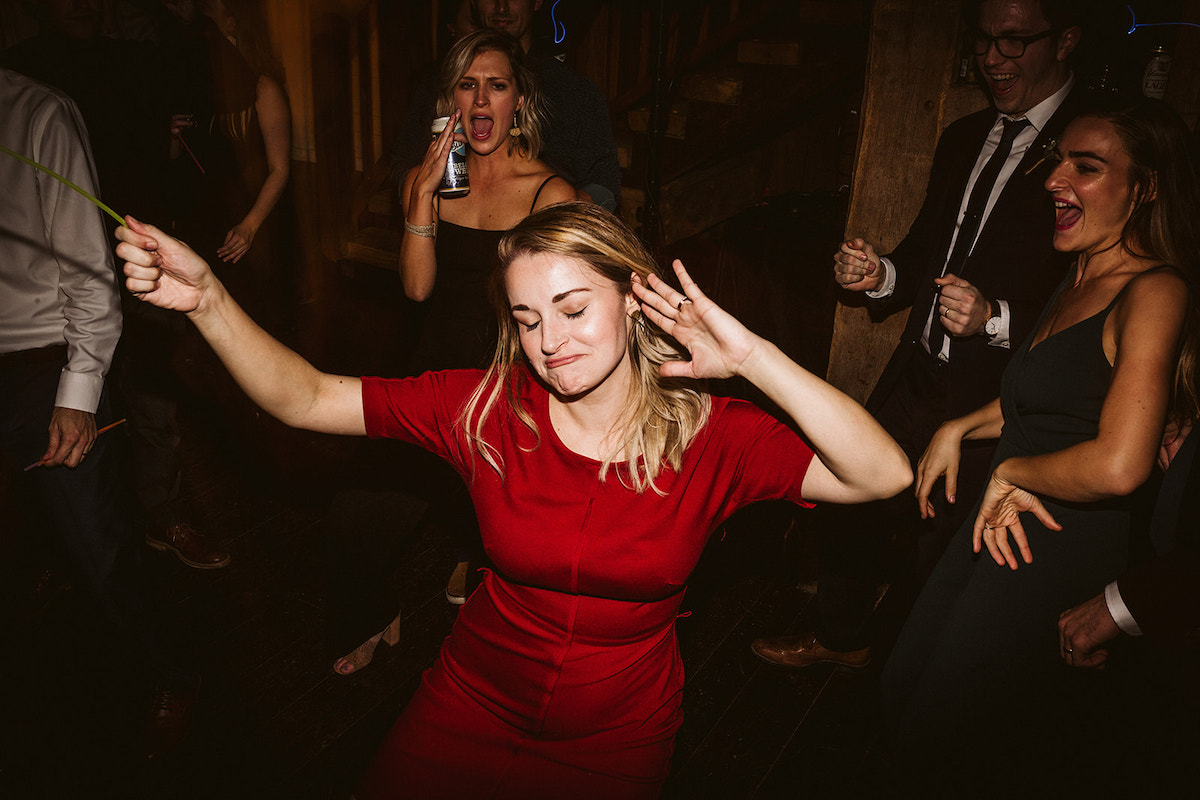 woman in red dress dances while holding a yellow glow stick