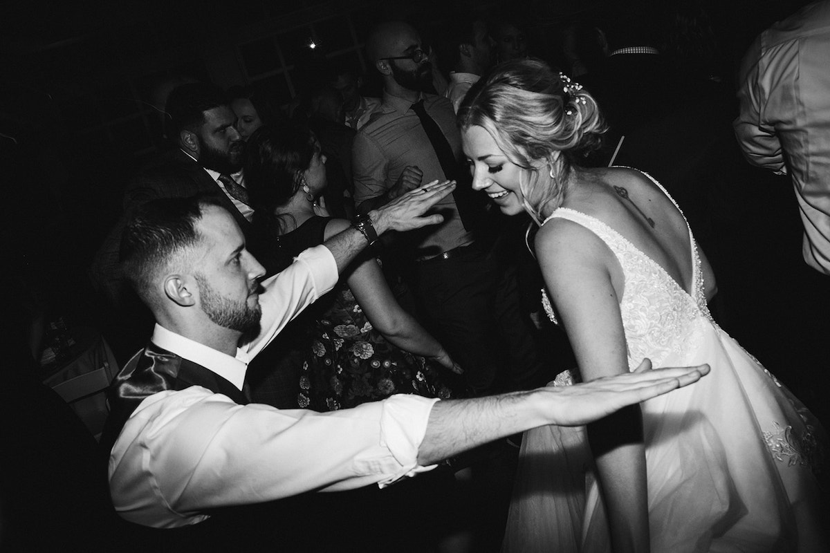 Groom holds out his arms as his bride dances toward him
