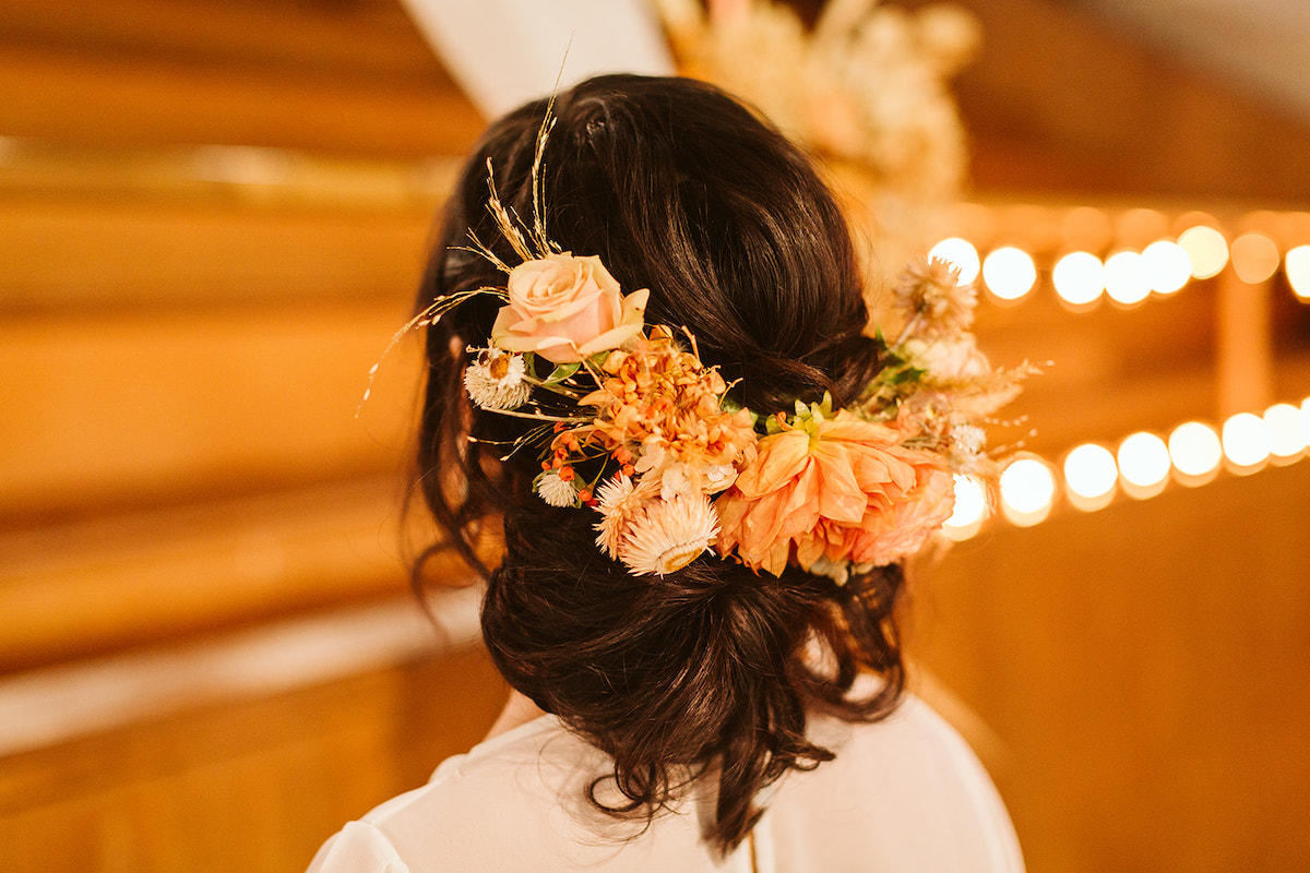 Bride's hair filled with Southerly Flower Farm pink and peach floral accents