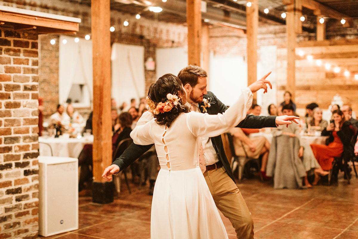 Groom and bride share their first dance during their reception at The Old Woolen Mill, a restored warehouse in Cleveland TN