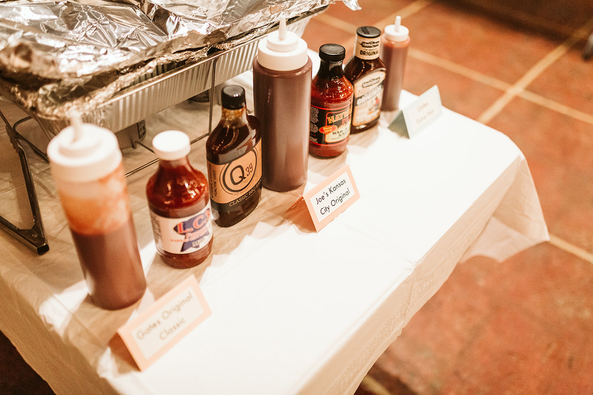 Multiple barbecue sauces lined up at the end of a table